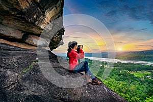 Tourist taking a photo at Pha taem national park in Ubon ratchathani, Thailand