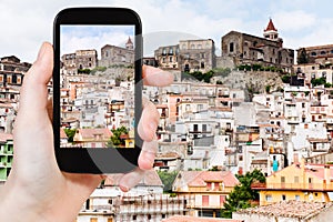 Tourist taking photo of small mountain town