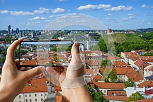 Tourist taking photo of Vilnius old town in Lithuania