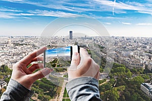 Tourist taking a picture of Aerial panoramic view of Paris.