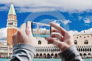 Tourist taking a picture of Campanile and Ducale or Doge Palace