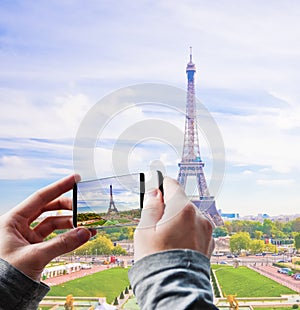 Tourist taking a picture of the Eiffel Tower