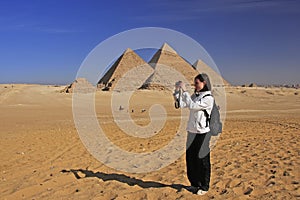 Tourist taking picture at Great Pyramids of Giza, Cairo