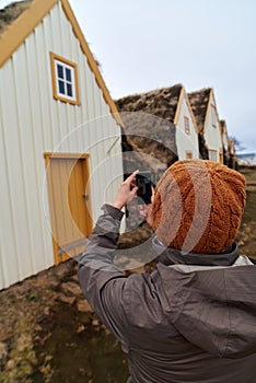 Tourist taking picture of historic farmhouse