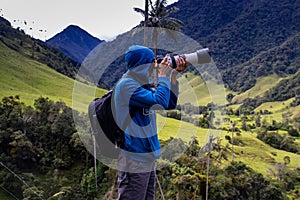 Tourist taking pictures at the beautiful Valle de Cocora located in Salento at the Quindio region in Colombia