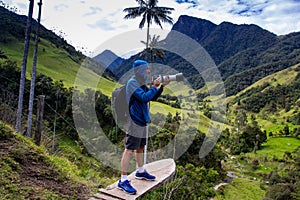 Tourist taking pictures at the beautiful Valle de Cocora located in Salento at the Quindio region in Colombia