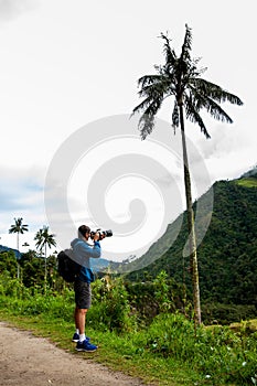 Tourist taking pictures at the beautiful Valle de Cocora located in Salento at the Quindio region in Colombia
