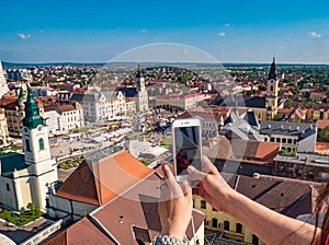 Tourist taking pictures from the City Hall Tower in Oradea, Romania