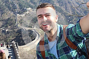 Tourist taking a selfie in the large Great Wall of China