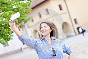 Tourist taking selfie in a town