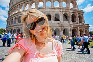 Tourist taking selfy photo in front of Colosseum in Rome