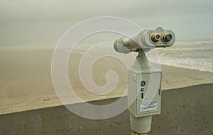 Tourist telescope placed on the beach to watch the boats