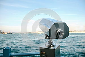 Tourist telescope with scenic view of the sea and blue skies. View of the Bosphorus, Istanbul, Turkey.