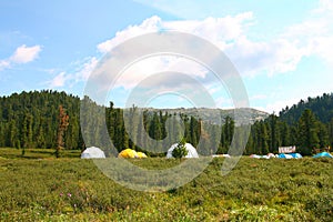 Tourist tent camp in a mountain valley.