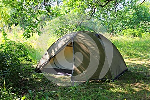 tourist tent on sunny meadow