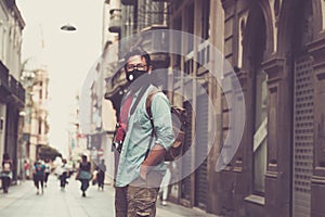 Tourist and tourism season in coroanvirus covid-19 emergeny restrictions - adult man standing outdoors on the street in the city