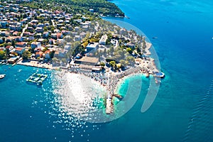 Tourist town of Selce and Poli Mora turquoise beach aerial view photo