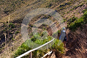 Tourist on a trail in Zingaro natural reserve near Scopello. Sicily Island