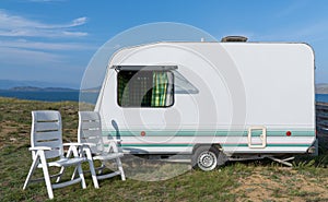 Tourist trailer on the shore of a beautiful lake