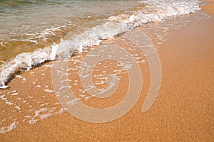 Tourist travel banner design template, copy space. White foam of a sea wave, golden sand beach, turquoise ocean water.