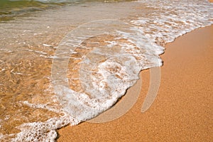 Tourist travel banner design template, copy space. White foam of a sea wave, golden sand beach, turquoise ocean water