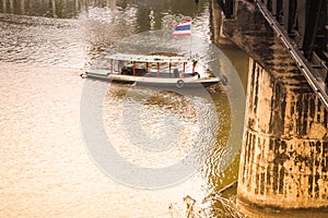 Tourist travel by Driving boat and the bridge over the river Kwai main historical landmark of Kanchanaburi Thailand