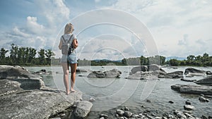 Tourist traveler with backpack. hiker view from back looking on hills and mountain river lake, girl enjoying nature panoramic