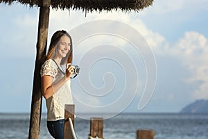 Tourist traveler girl enjoying holidays looking a seascape on the beach