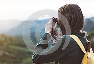 Tourist traveler photographer taking pictures of amazing landscape on vintage photo camera on background valley view mockup sun