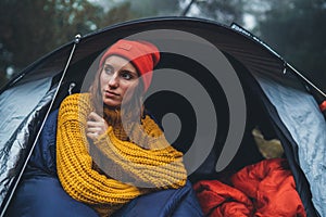 Tourist traveler ralaxing in camp tent in froggy rain forest, hiker woman enjoy mist nature trip, green trekking tourism, rest