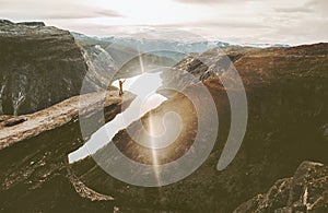 Tourist on Trolltunga cliff edge in Norway adventure travel