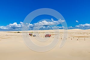 Tourist Trucks driving on Sand Dunes at Stockton Beach, New South Wales, Australia