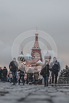 A tourist uses his smartphone to take a picture of famous St. Basil`s Cathedral at Red Square in Moscow, Russia