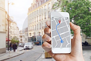 Tourist using GPS map navigation app on smartphone screen, direction