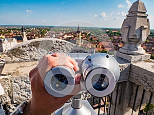 Tourist using street binoculars in Oradea