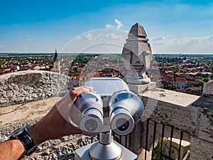 Tourist using street binoculars in Oradea Romania