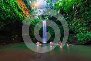 Tourist visits Tibumana waterfall which is famous place & top travel destination in Bali,Indonesia.Blur the tourist image.