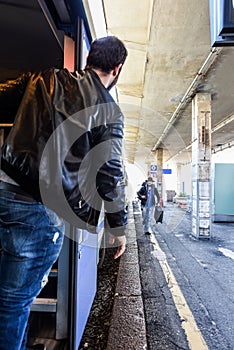 Tourist is waiting for his friend to get on the train.