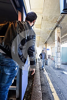 Tourist is waiting for his friend to get on the train.