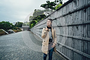 Tourist walk along bamboo wall on stone road