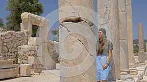 Tourist walking in colonnaded street in Patara, Turkey