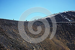 Tourist walking on Crater In Etna Park, Sicily