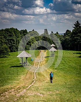 A tourist walking down a path from Swiety Krzyz mountain, Poland.