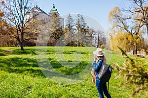 Tourist walking in Olesko Castle garden. Ancient architecture landmarks in Western Ukraine. Traveling