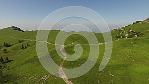 Tourist Walking On A Path In Beautiful Green Mountain