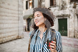 Tourist walking on the street in european old city drink coffee