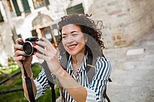 Tourist walking on the street in european old city using camera