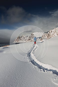 Tourist walking in the wild on the Lofoten Islands in Norway