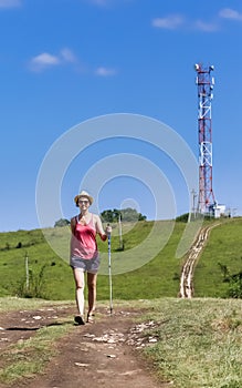 A tourist walks on the road in the background communications tower