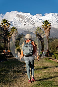 Tourist walks in a town located in the foothills of the snow-capped Huascaran mountain.